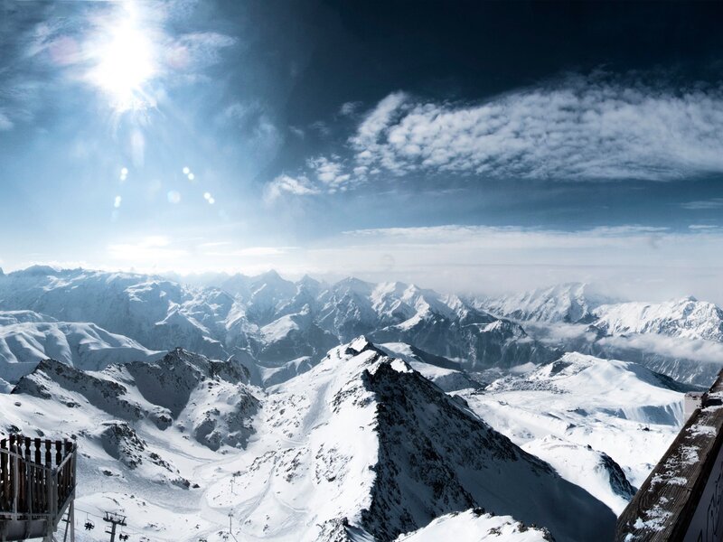 Snowy mountain peaks under sun