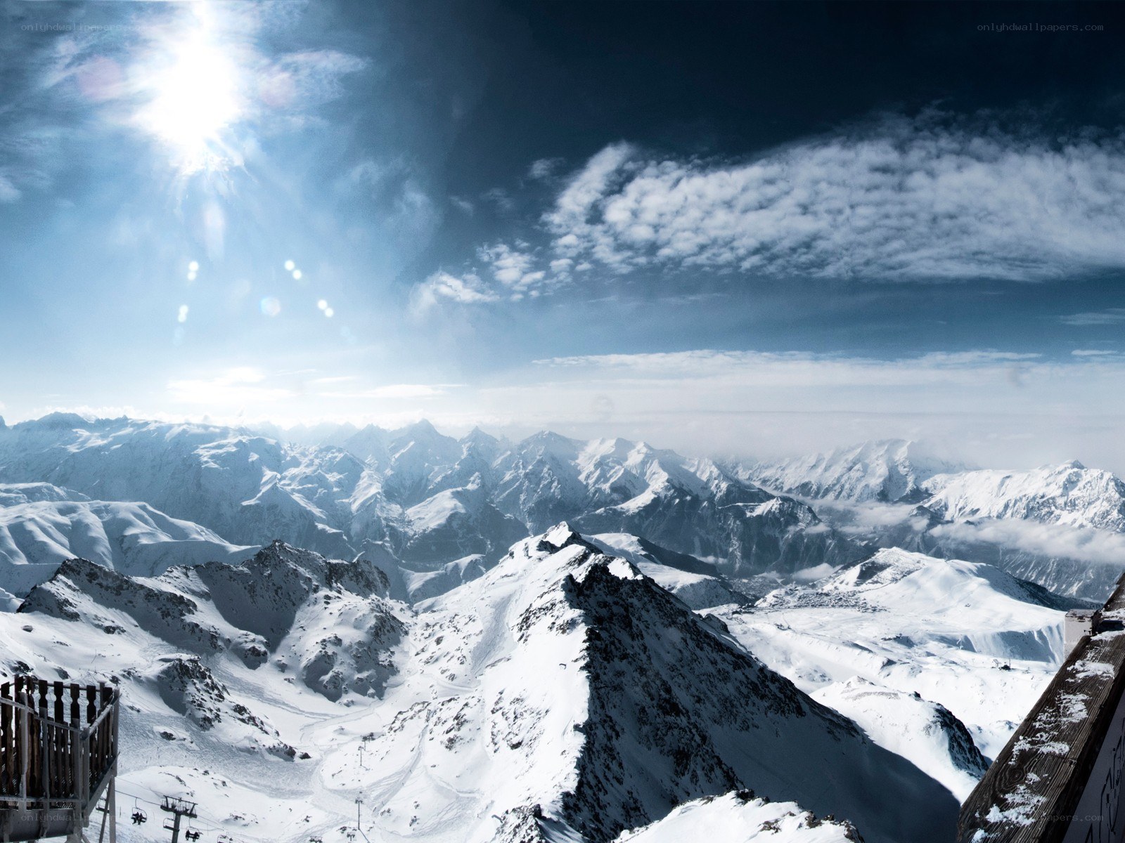 Snowy mountain peaks under sun