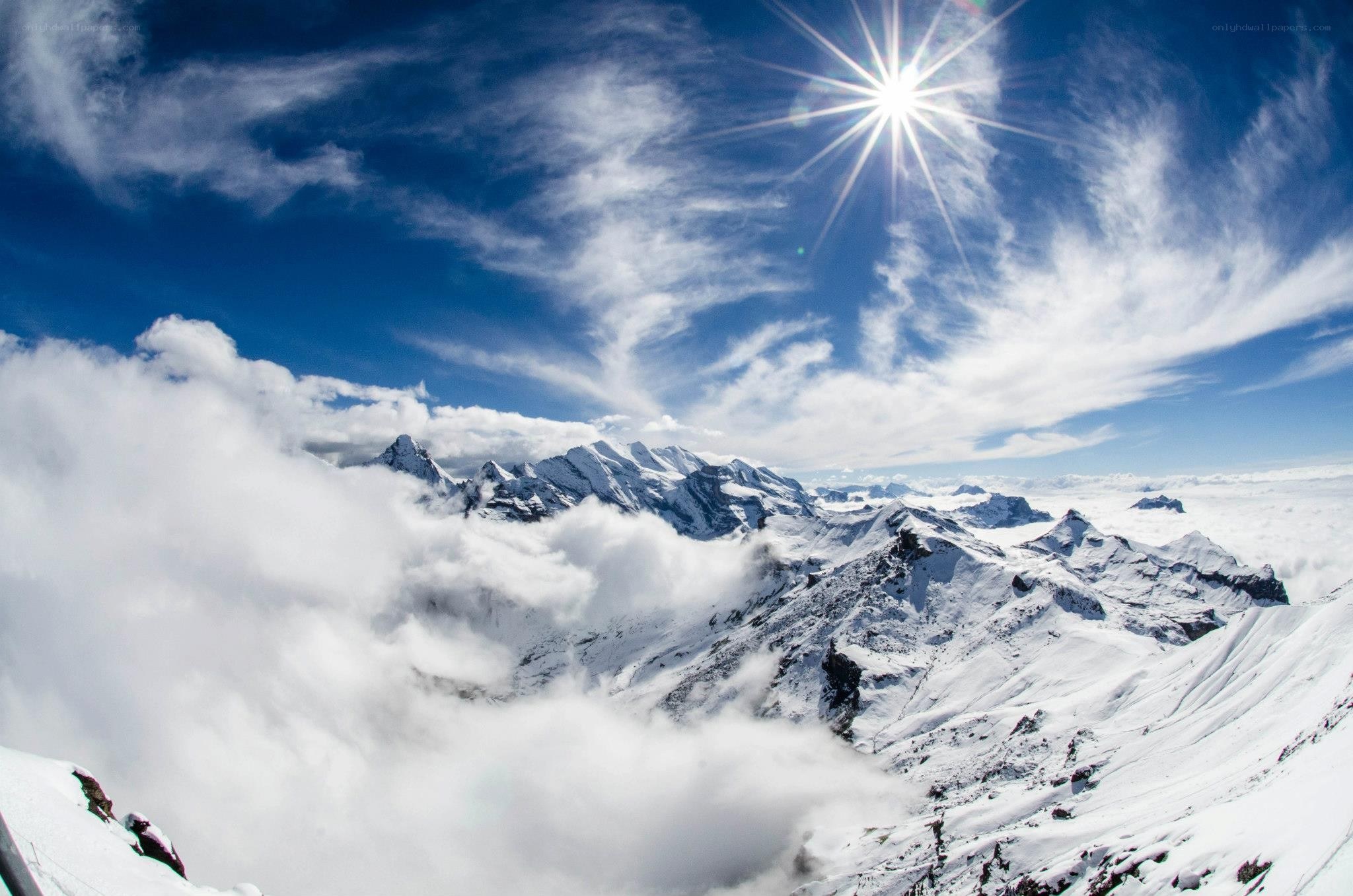 Snowy mountain peaks under sun
