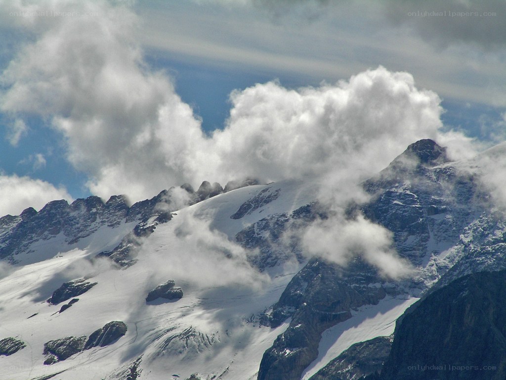 Snowy mountain peaks with clouds