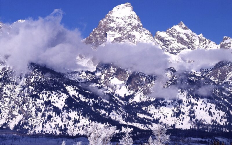 Snowy mountain peaks with clouds
