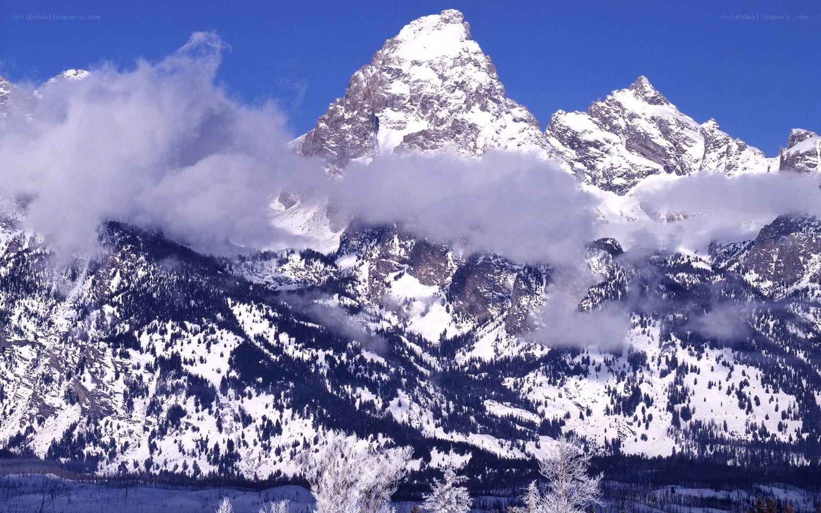Snowy mountain peaks with clouds
