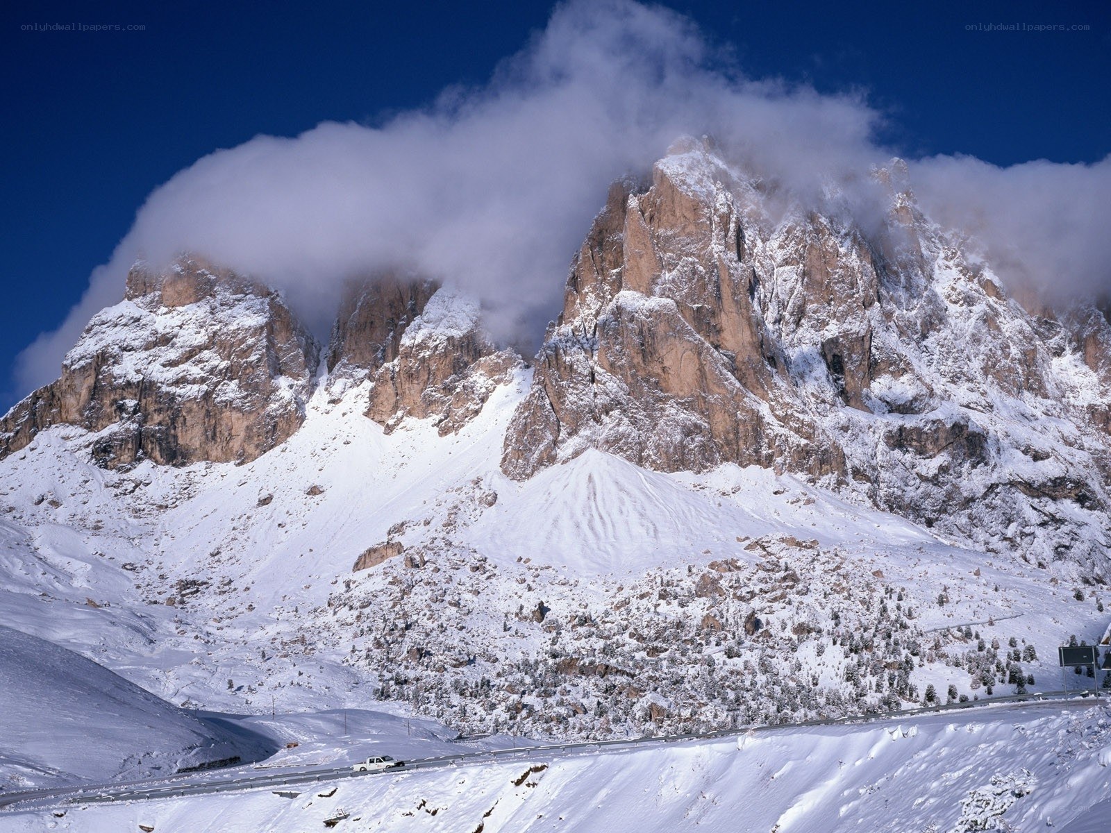 Snowy mountain peaks with clouds