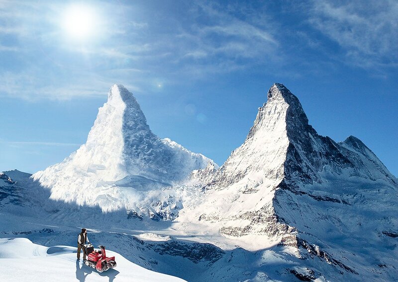 Snowy mountain peaks with snowmobile