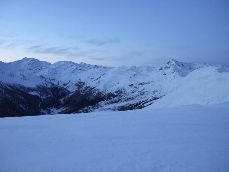 snowy mountain range at dusk