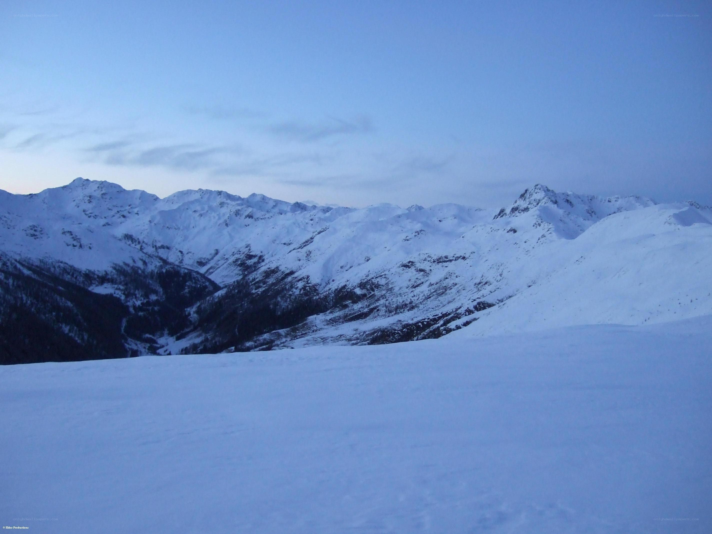 snowy mountain range at dusk