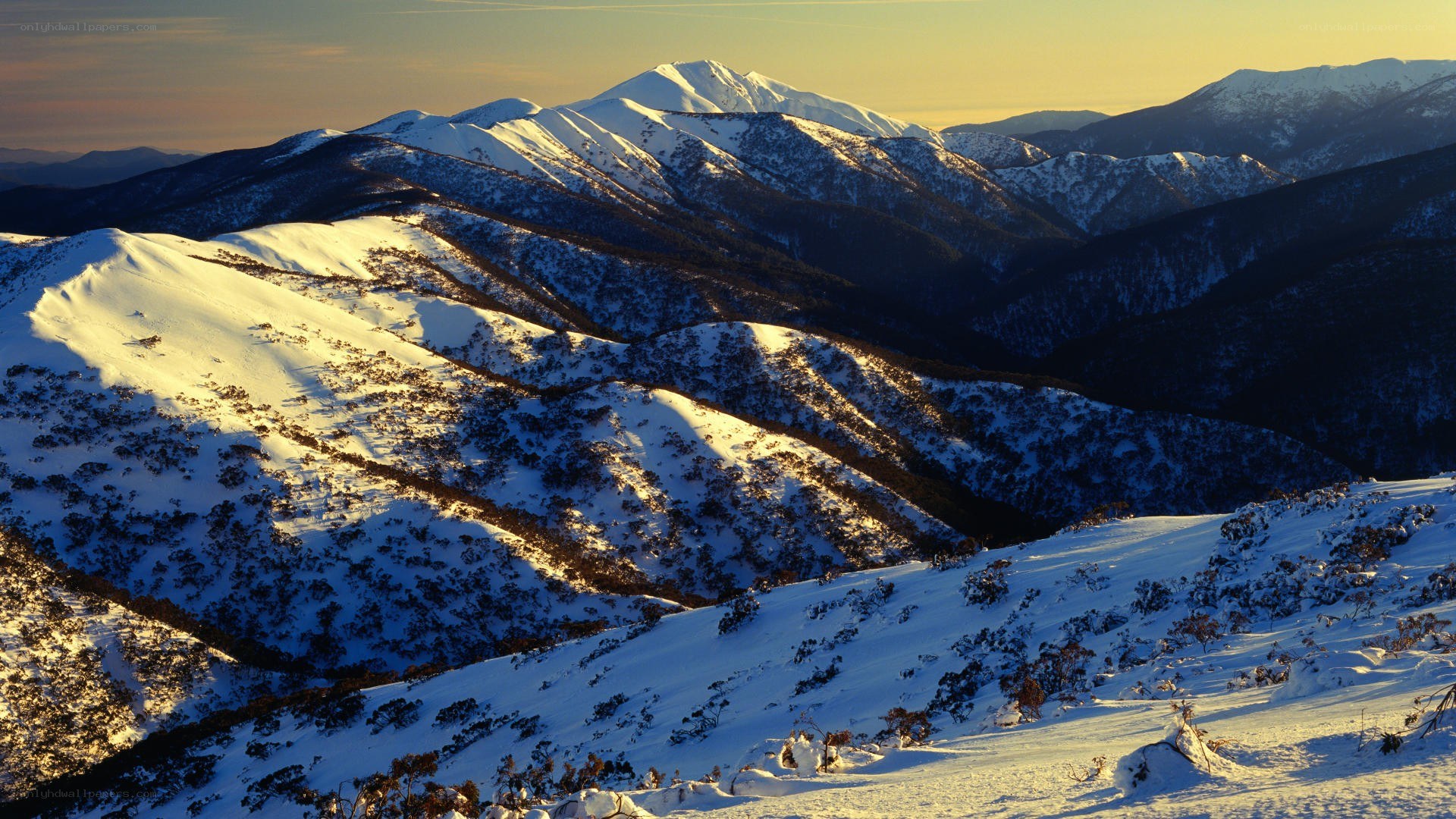 Snowy mountain range at sunset