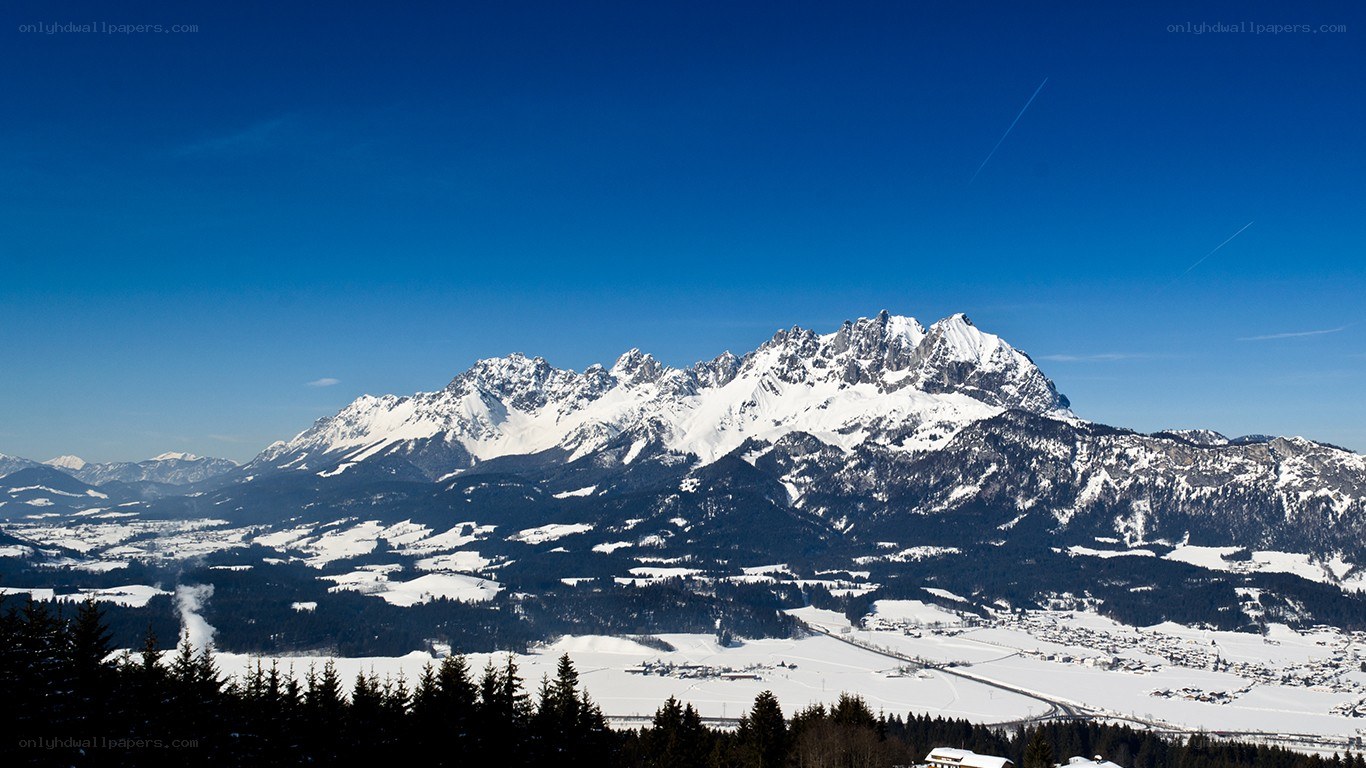 snowy mountain range under blue sky