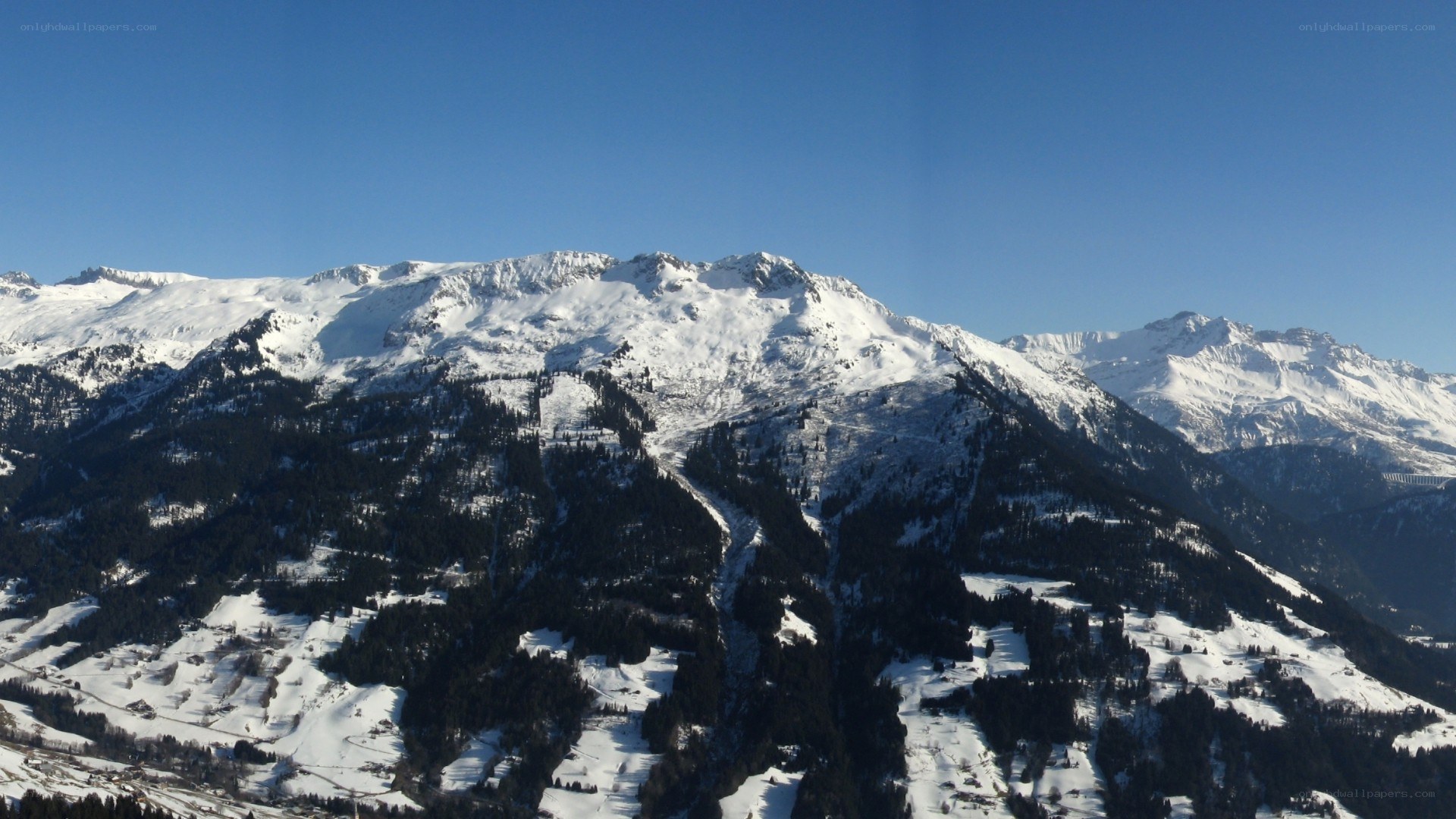 snowy mountain range under blue sky