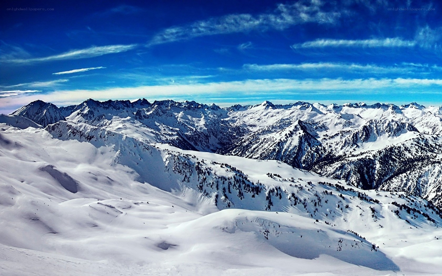 Snowy mountain range under blue sky