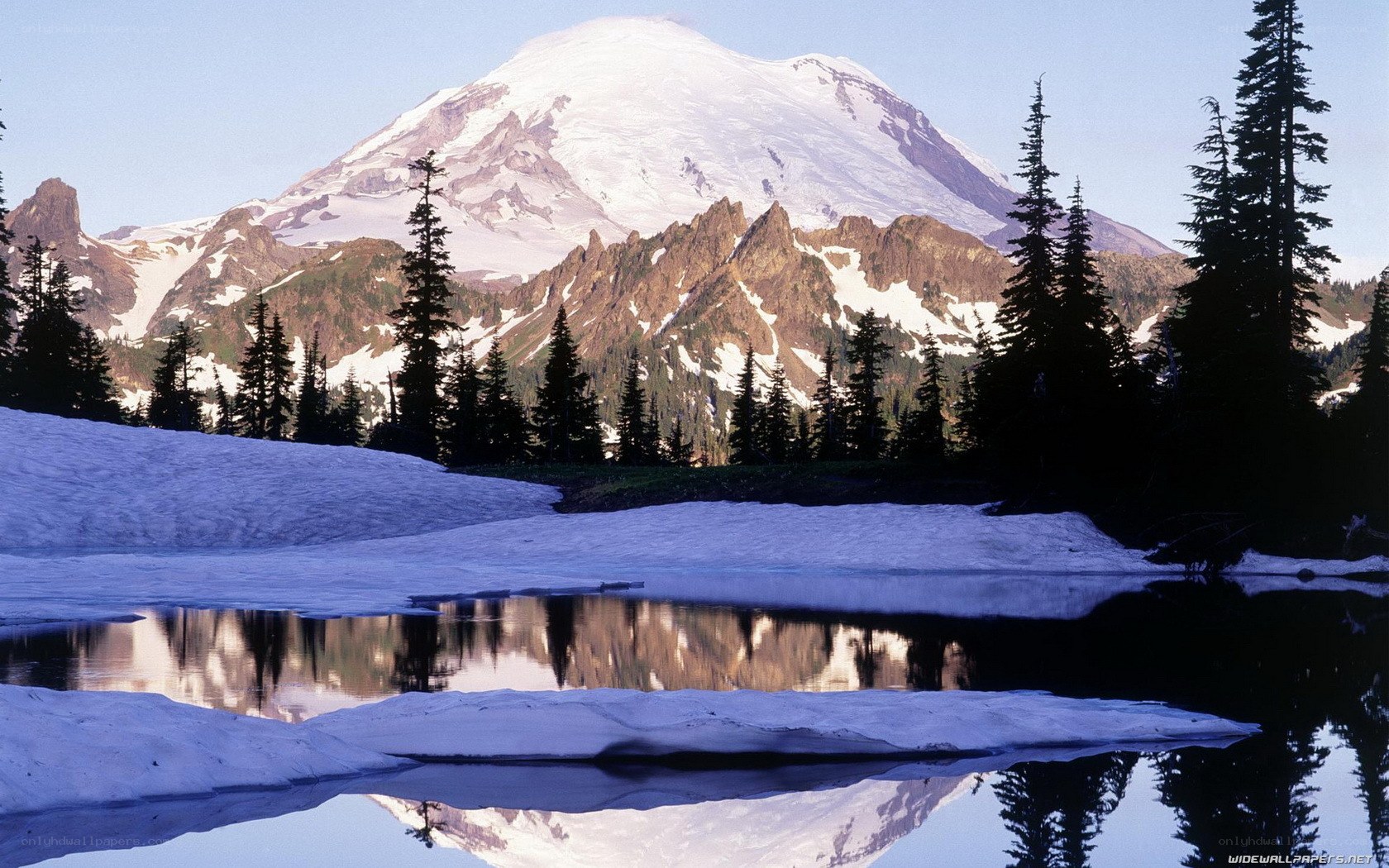 Snowy mountain reflected in a lake