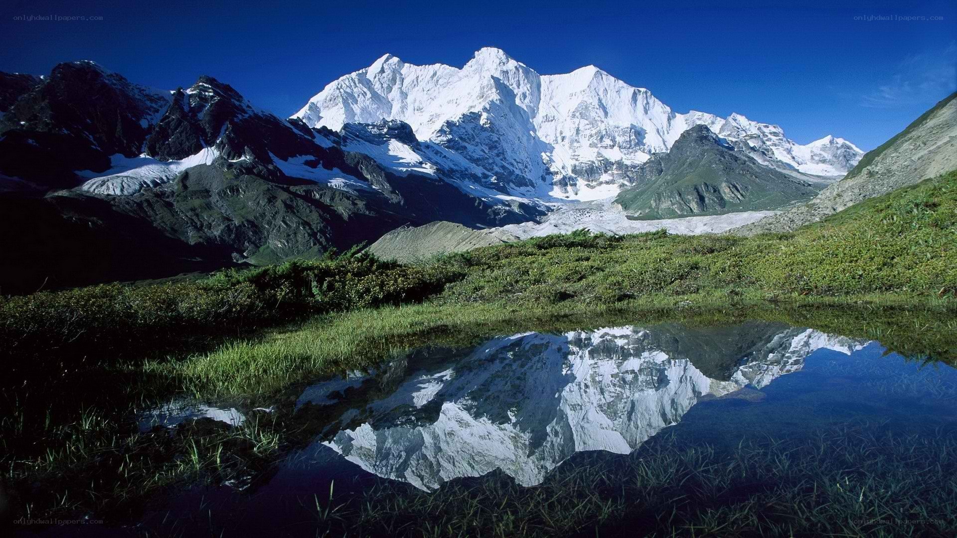 Snowy mountain reflected in a pond