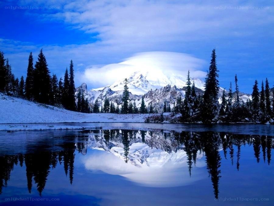 Snowy mountain reflected in lake