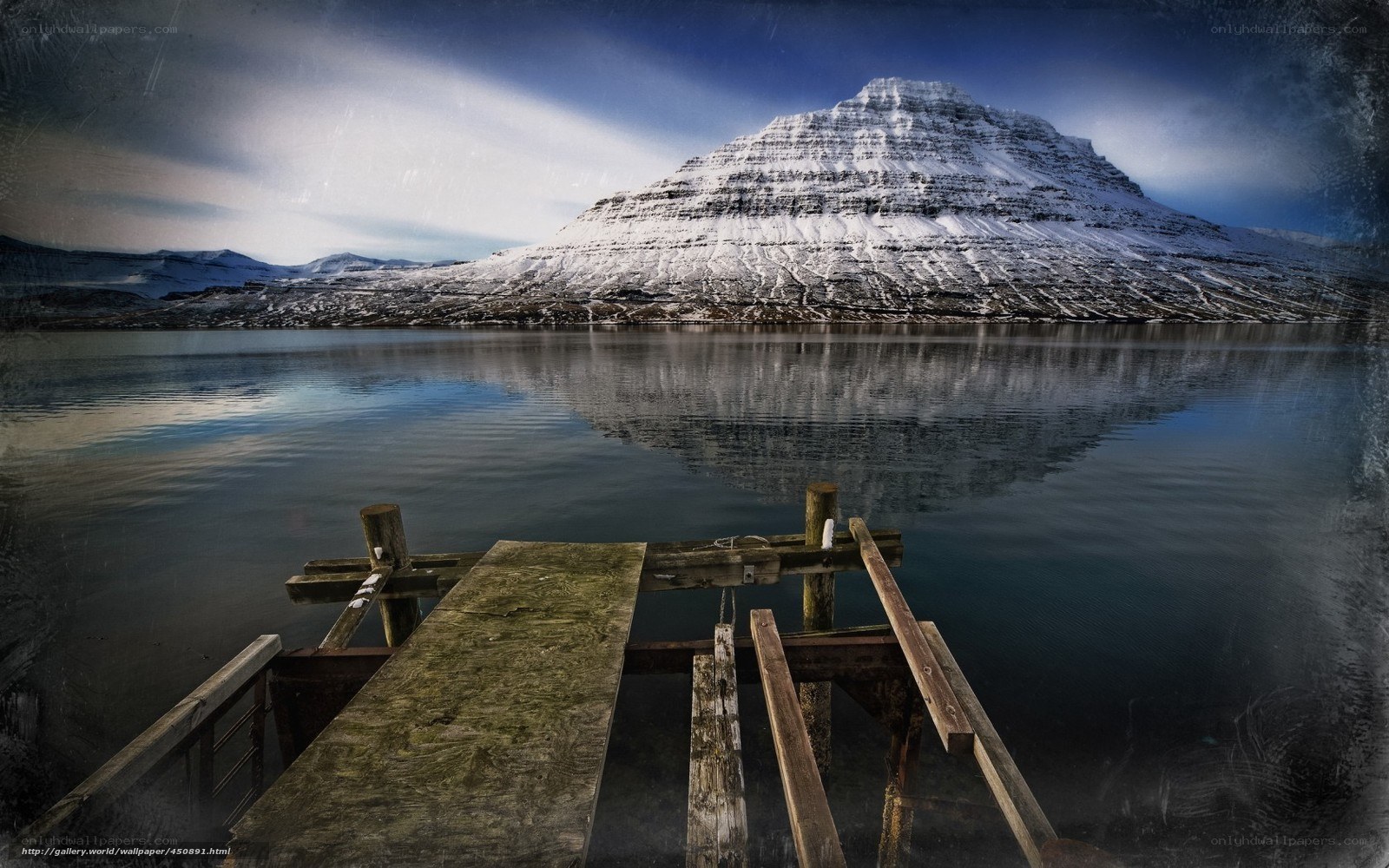 Snowy mountain reflected in lake
