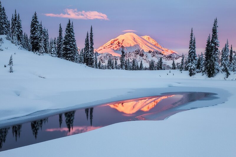 Snowy mountain reflection at dawn