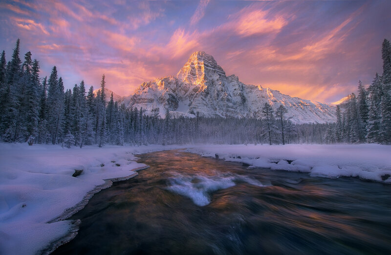 Snowy mountain river at sunset