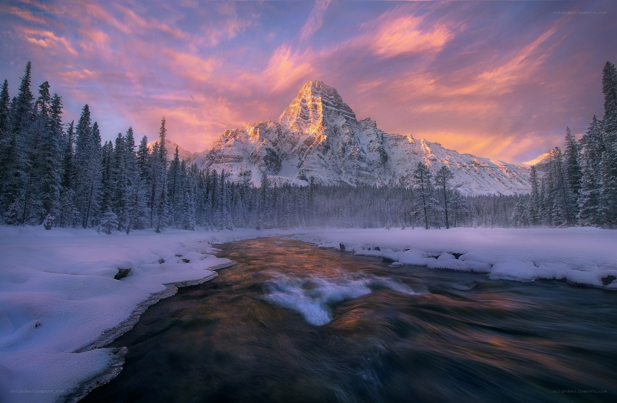 Snowy mountain river at sunset