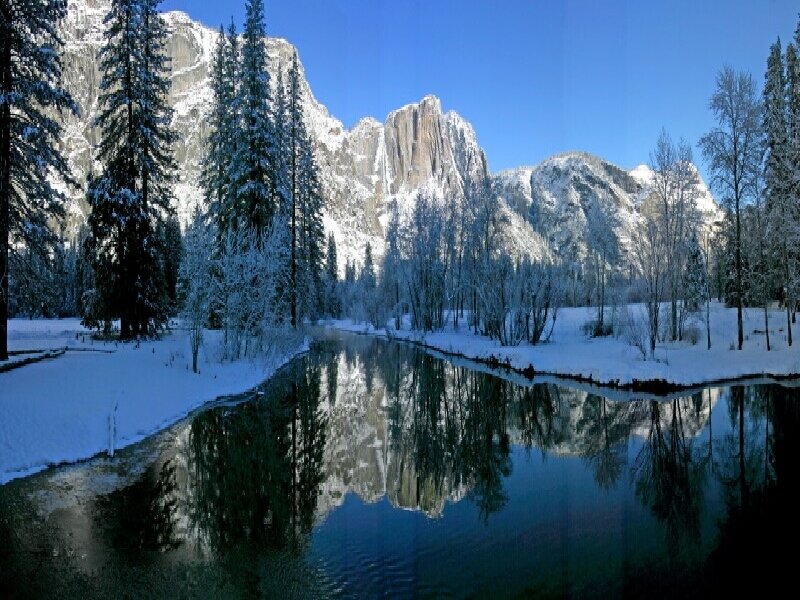 Snowy mountain river reflection