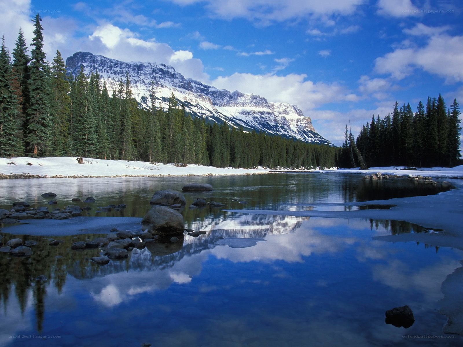 Snowy mountain river reflection