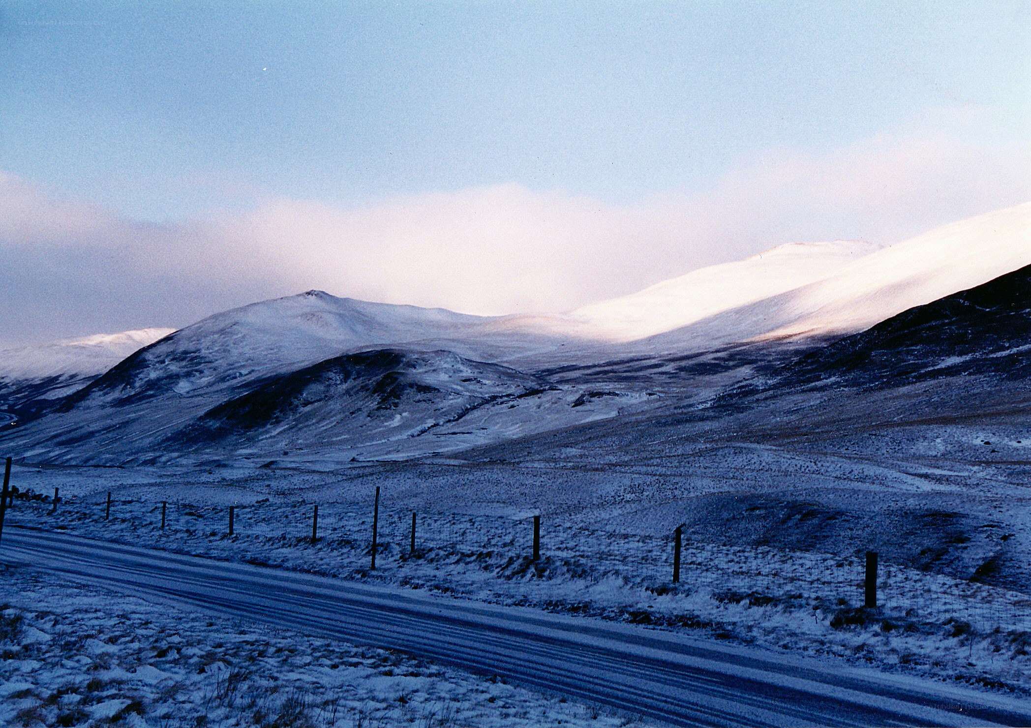 Snowy mountain road at dusk