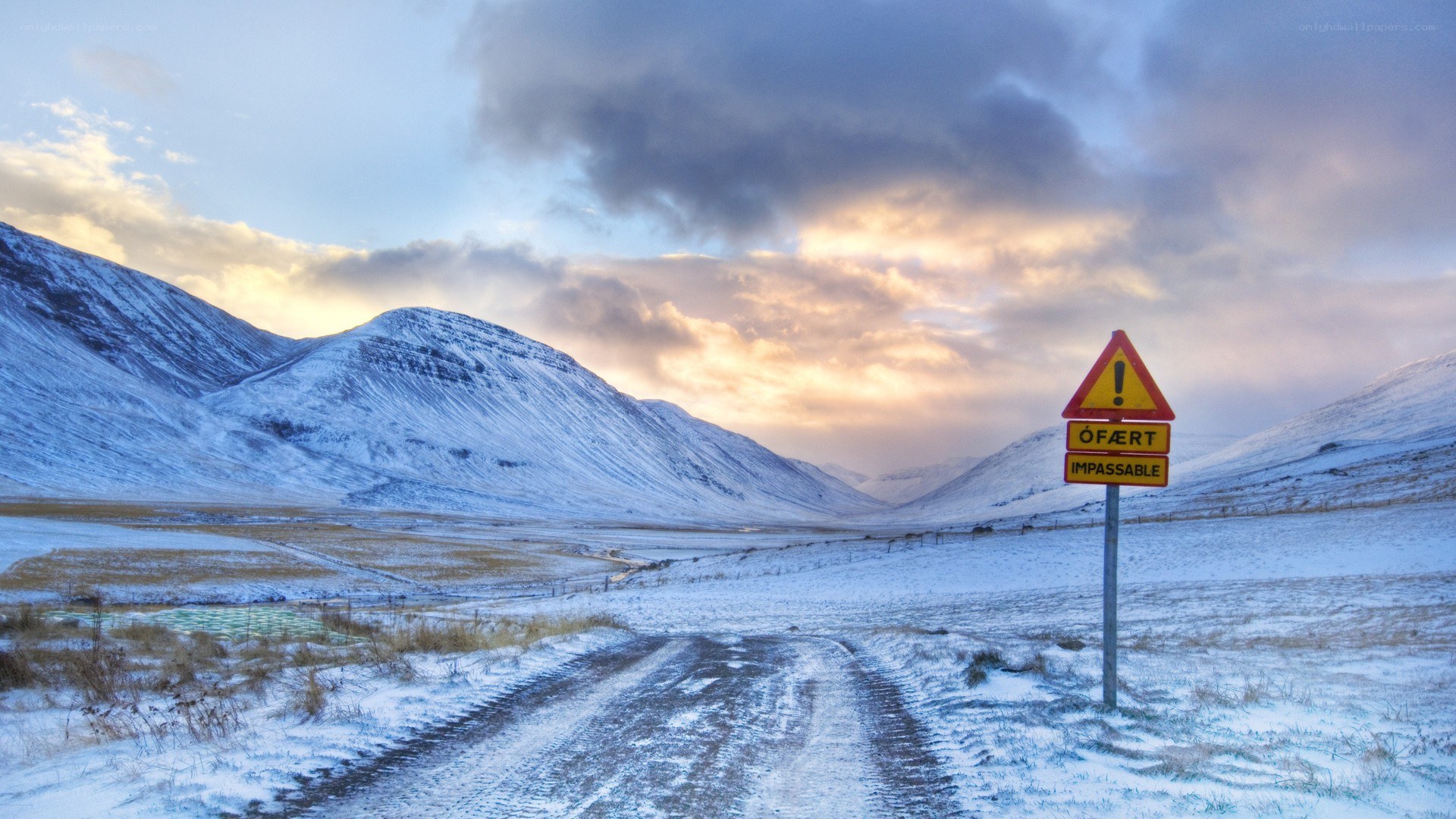 Snowy mountain road sign