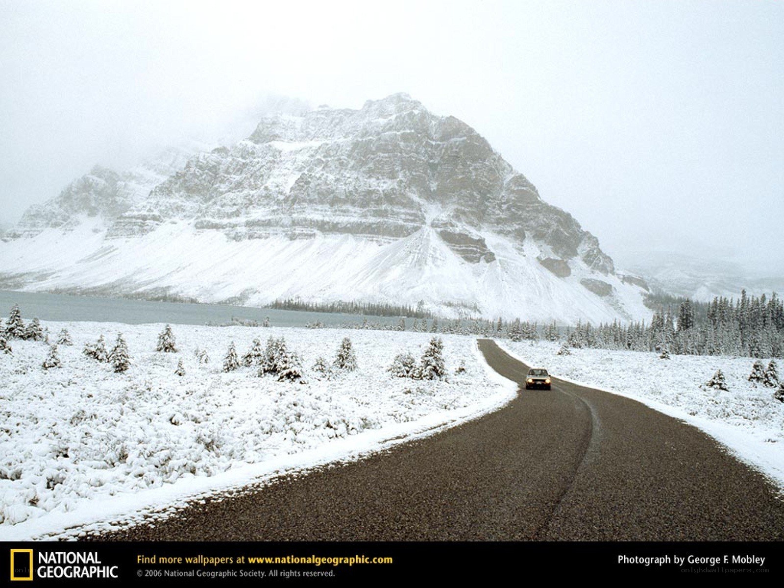 Snowy mountain road with car