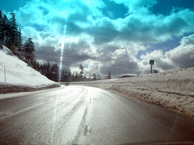 Snowy mountain road with clouds