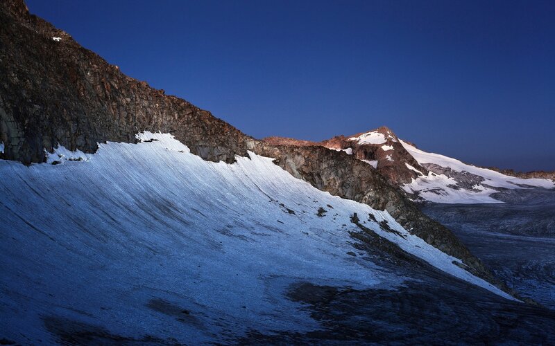 Snowy mountain slopes at dusk