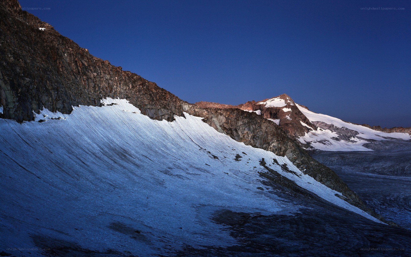Snowy mountain slopes at dusk