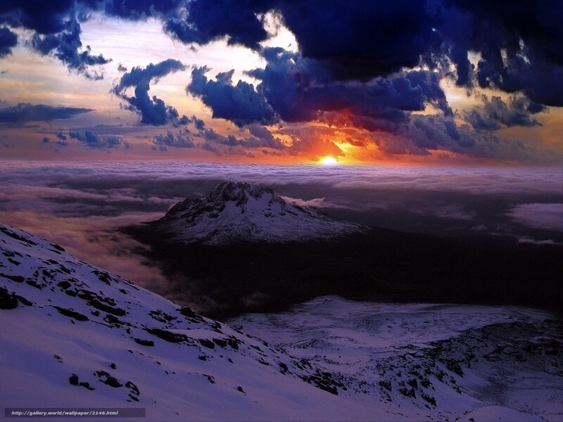 Snowy mountain sunset over clouds
