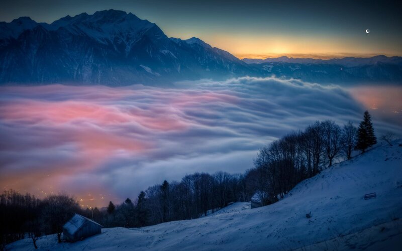 Snowy mountain sunset with clouds