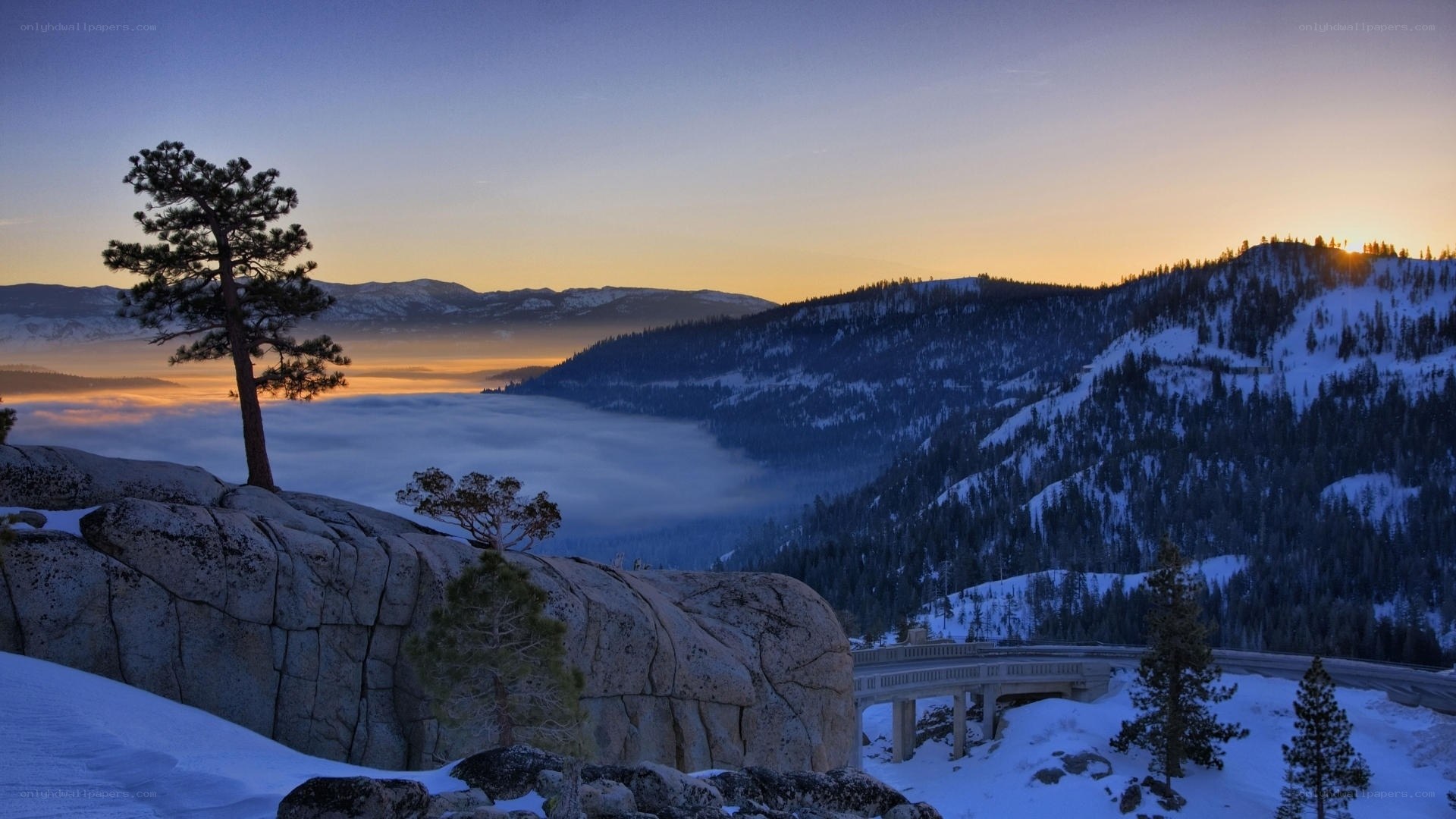 Snowy mountain sunset with fog