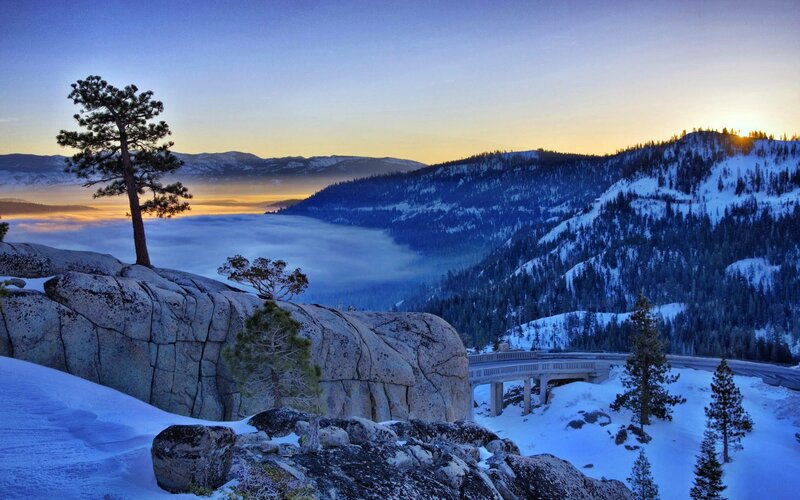 Snowy mountain sunset with fog