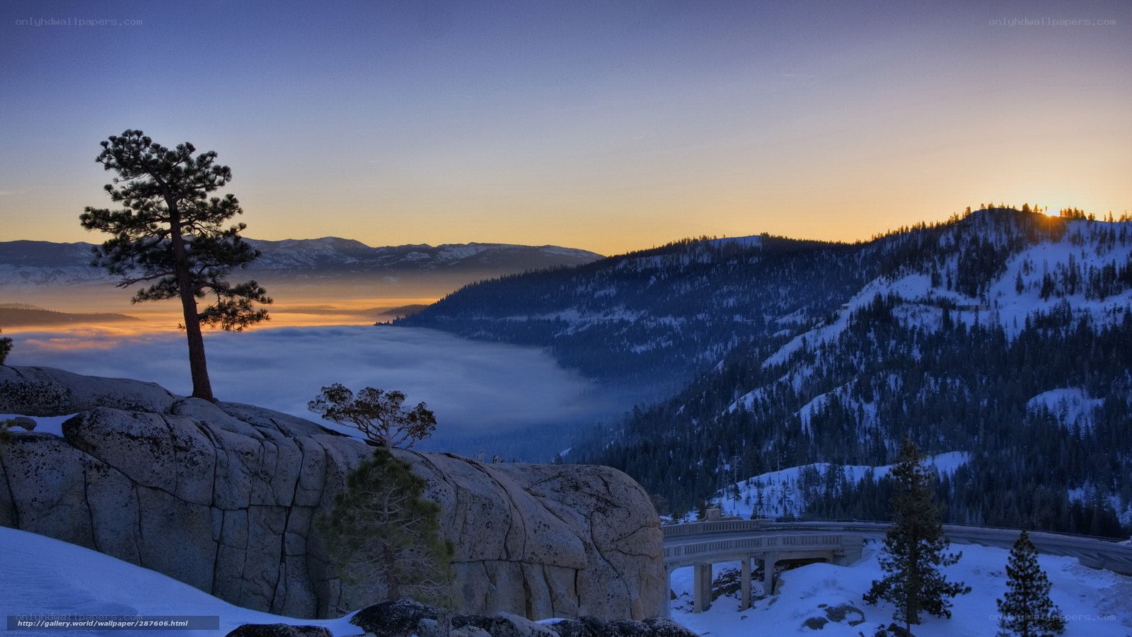 Snowy mountain sunset with fog