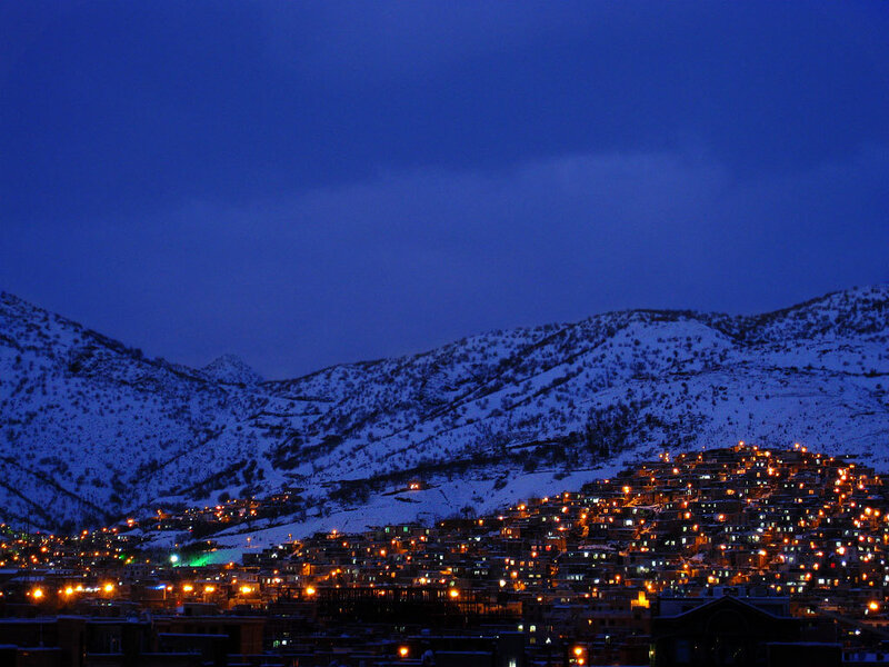 Snowy mountain town at night