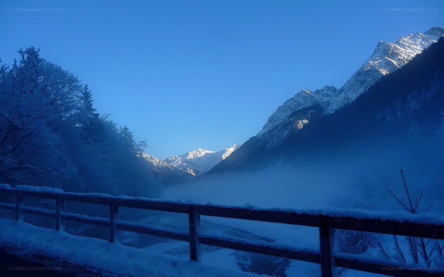 Snowy mountain valley at dawn