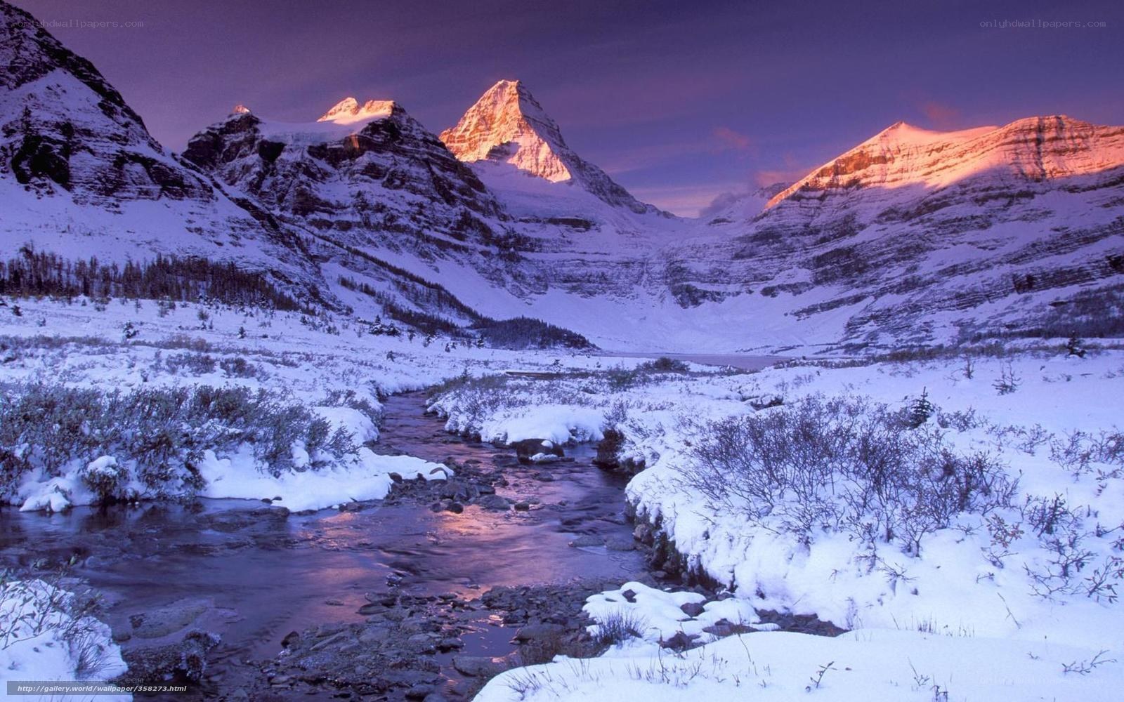 Snowy mountain valley at sunset