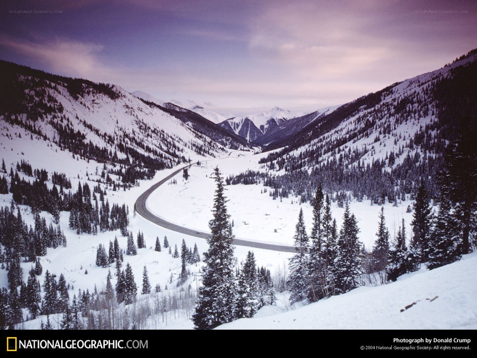 Snowy mountain valley road