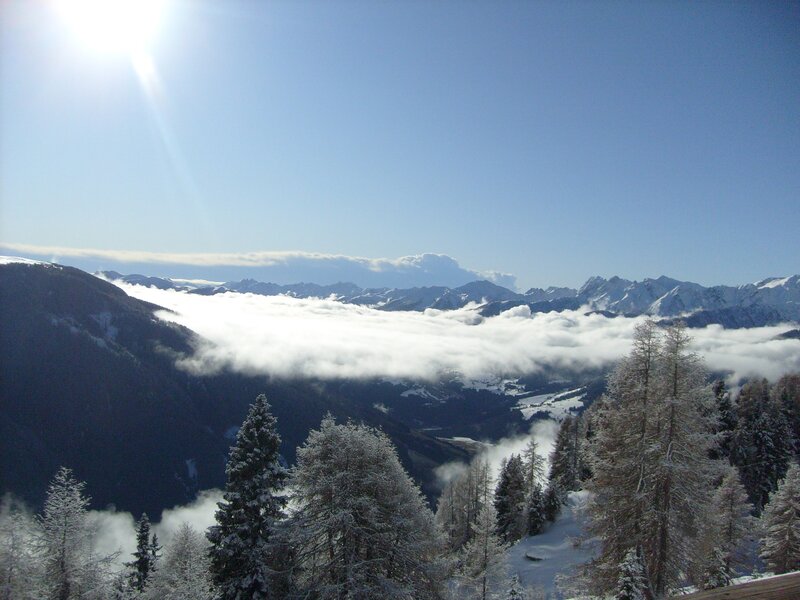 Snowy mountain valley with clouds