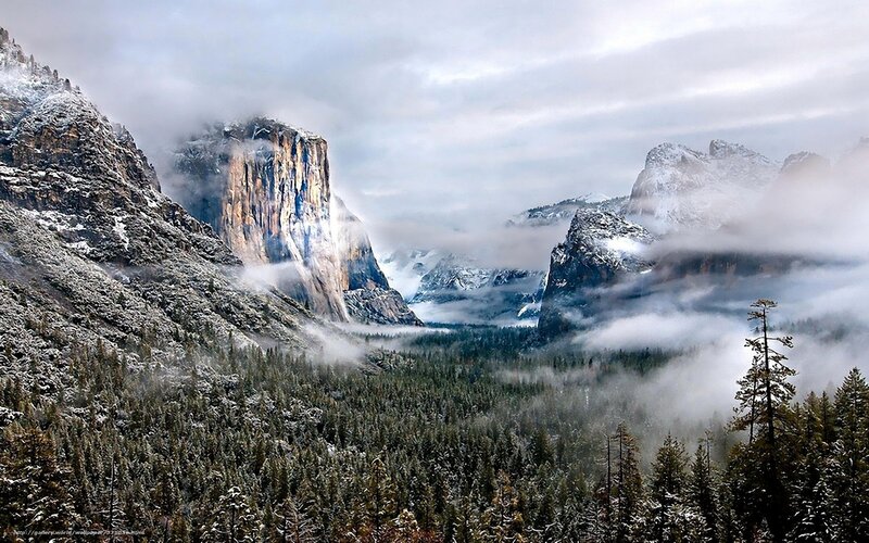 Snowy mountain valley with fog