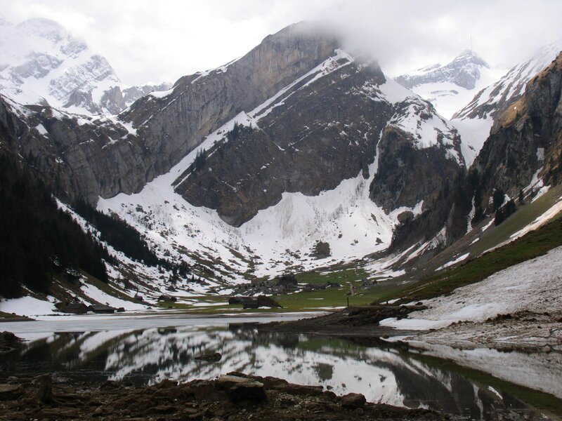 snowy mountain valley with lake