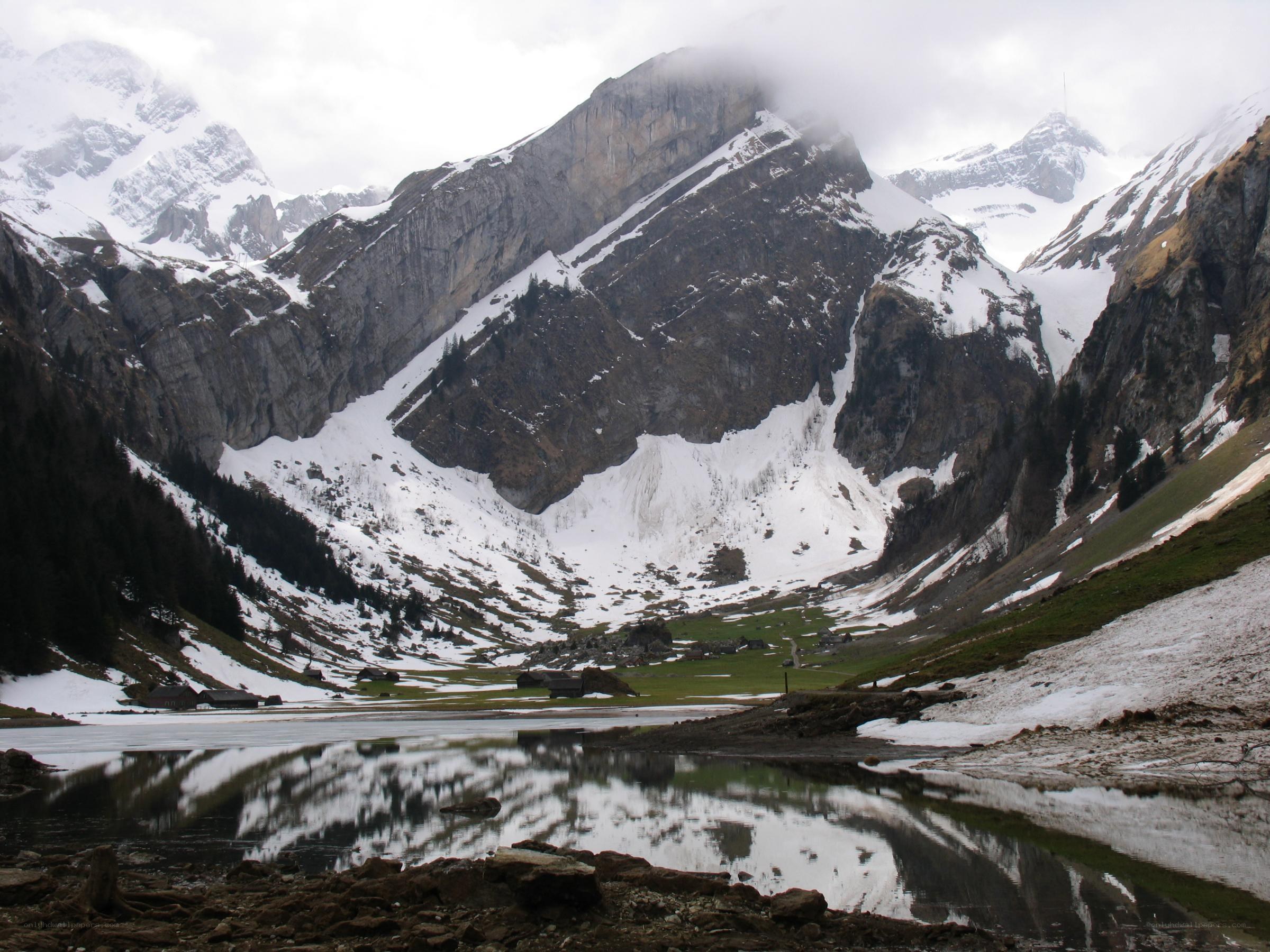 snowy mountain valley with lake