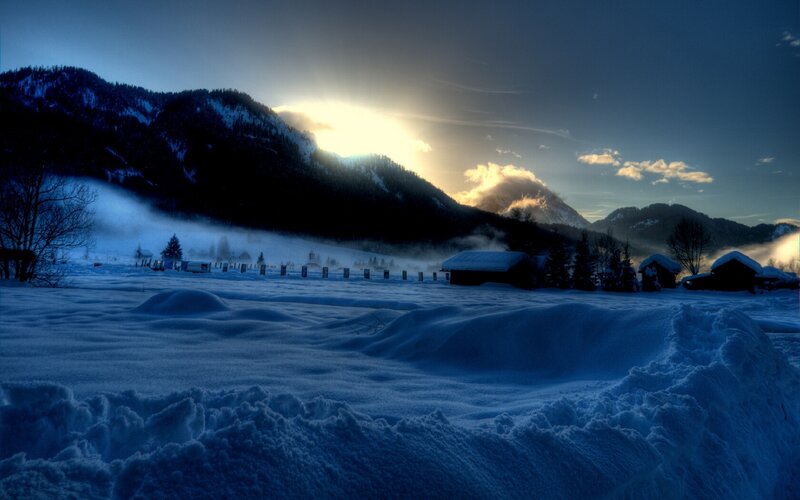 Snowy mountain village at dawn