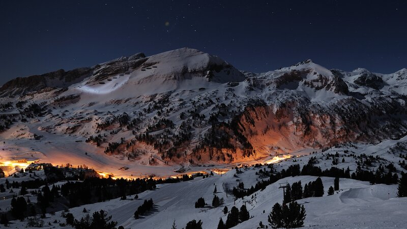 Snowy mountain village at night