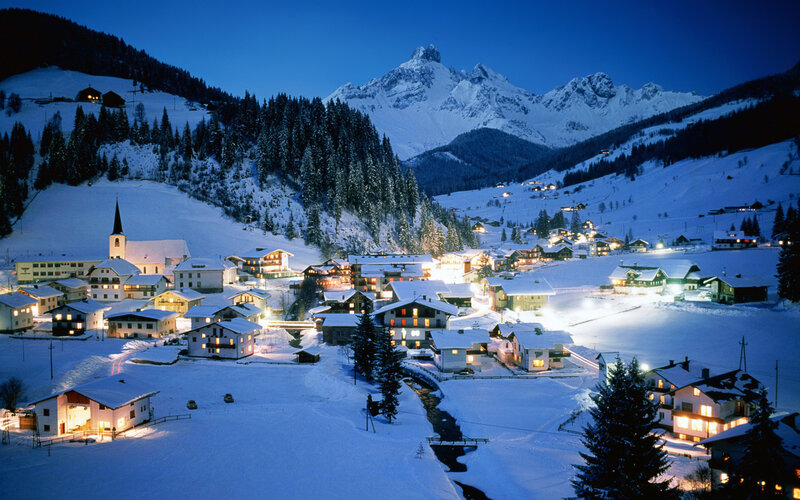 Snowy mountain village at night