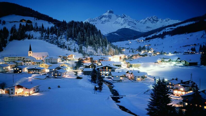 Snowy mountain village at night