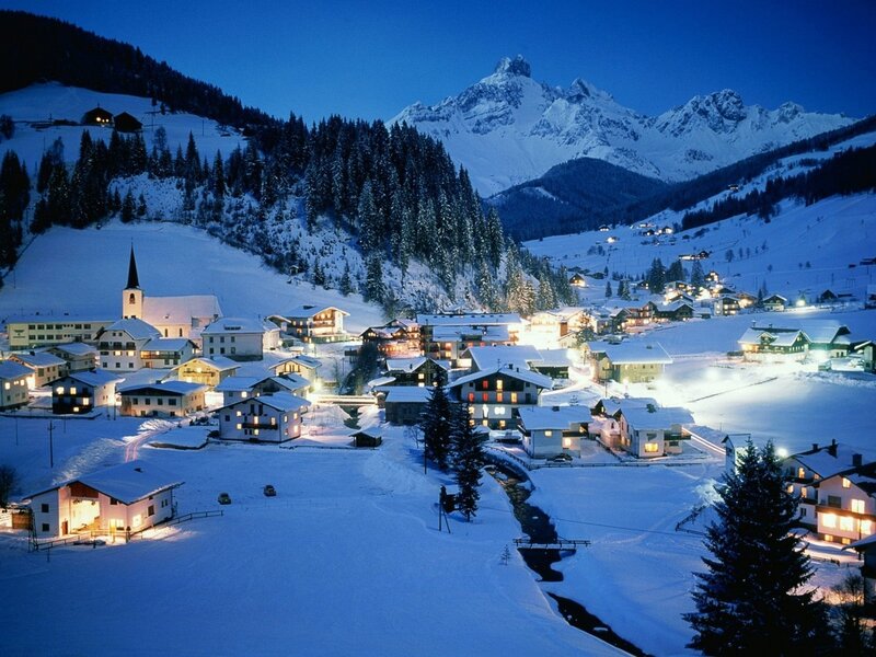 Snowy mountain village at night