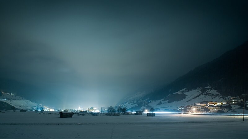 Snowy mountain village at night