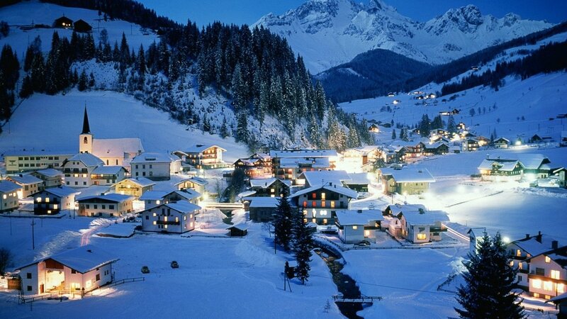 Snowy mountain village at night