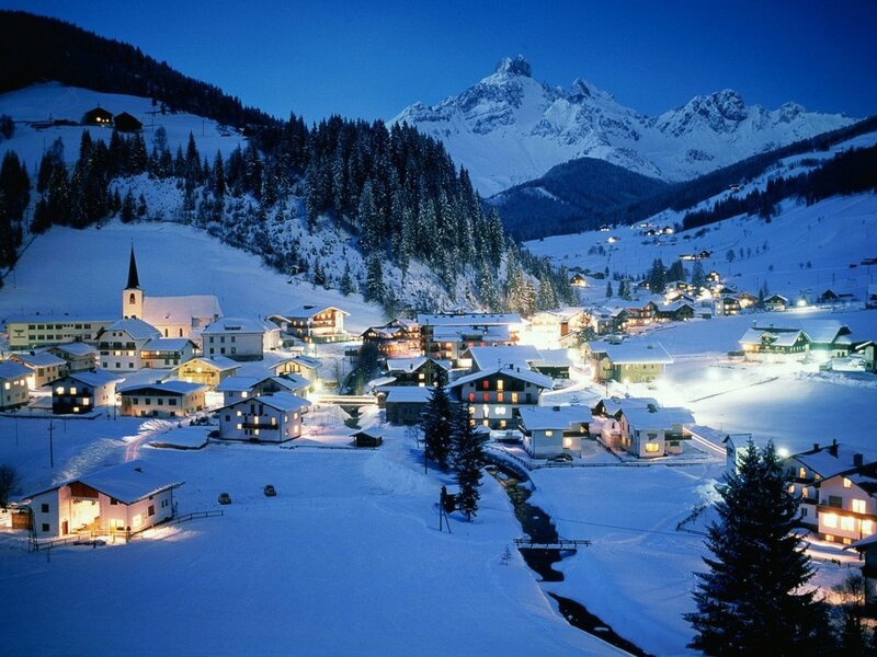 Snowy mountain village at night